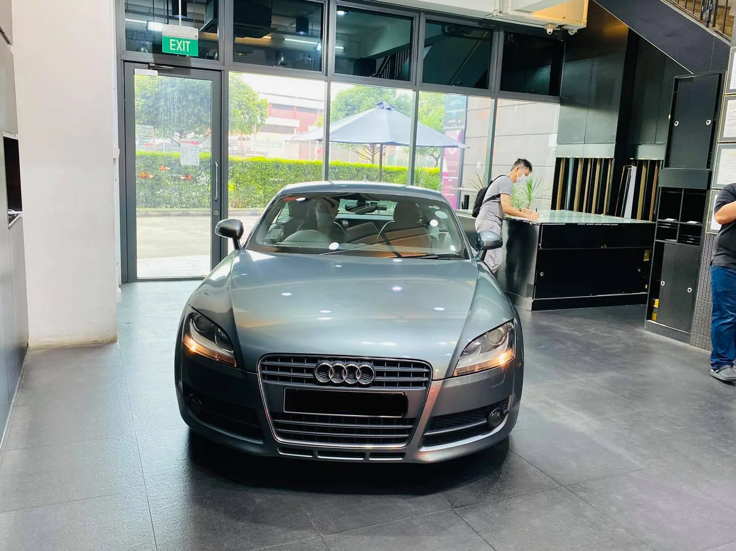 Grey Audi TT with passenger door open during window tinting at Infratint Singapore