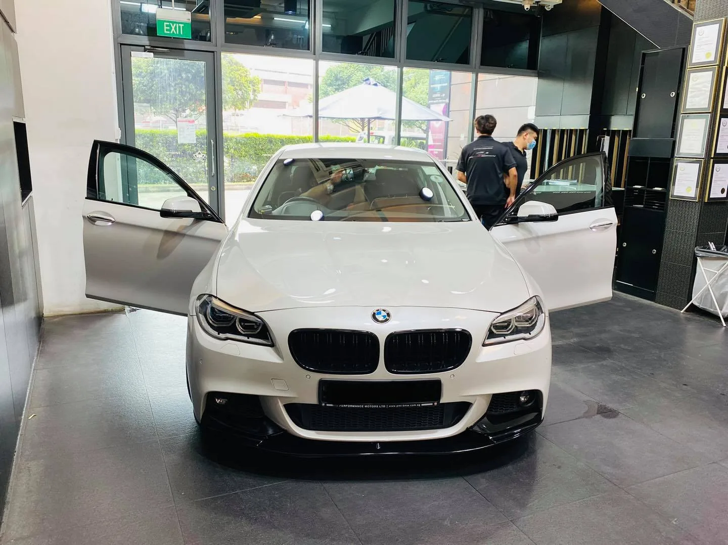 White BMW 5 Series front view with doors open at Infratint Singapore
