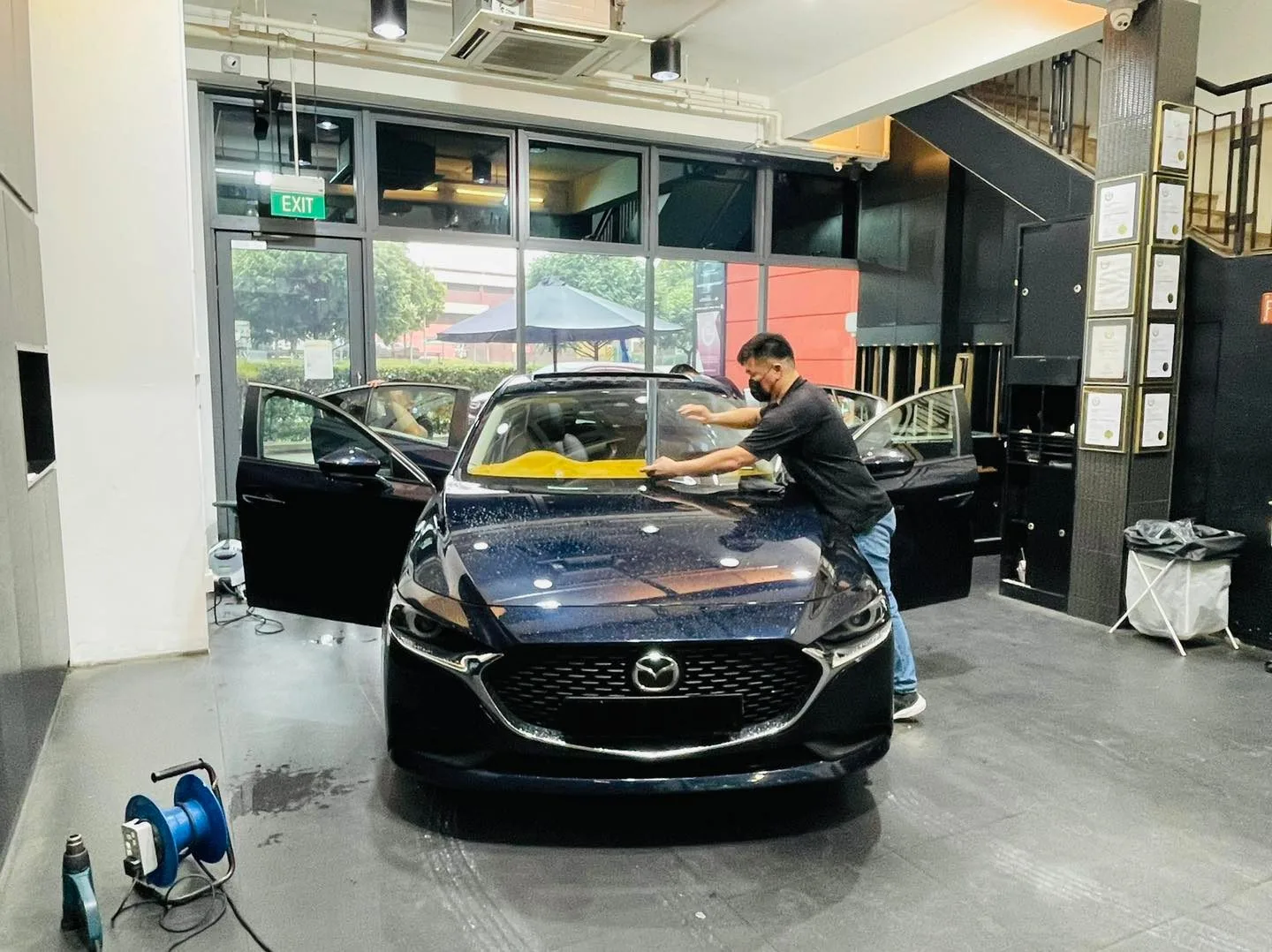 Dark blue Mazda 3 sedan getting windscreen film at Infratint Singapore