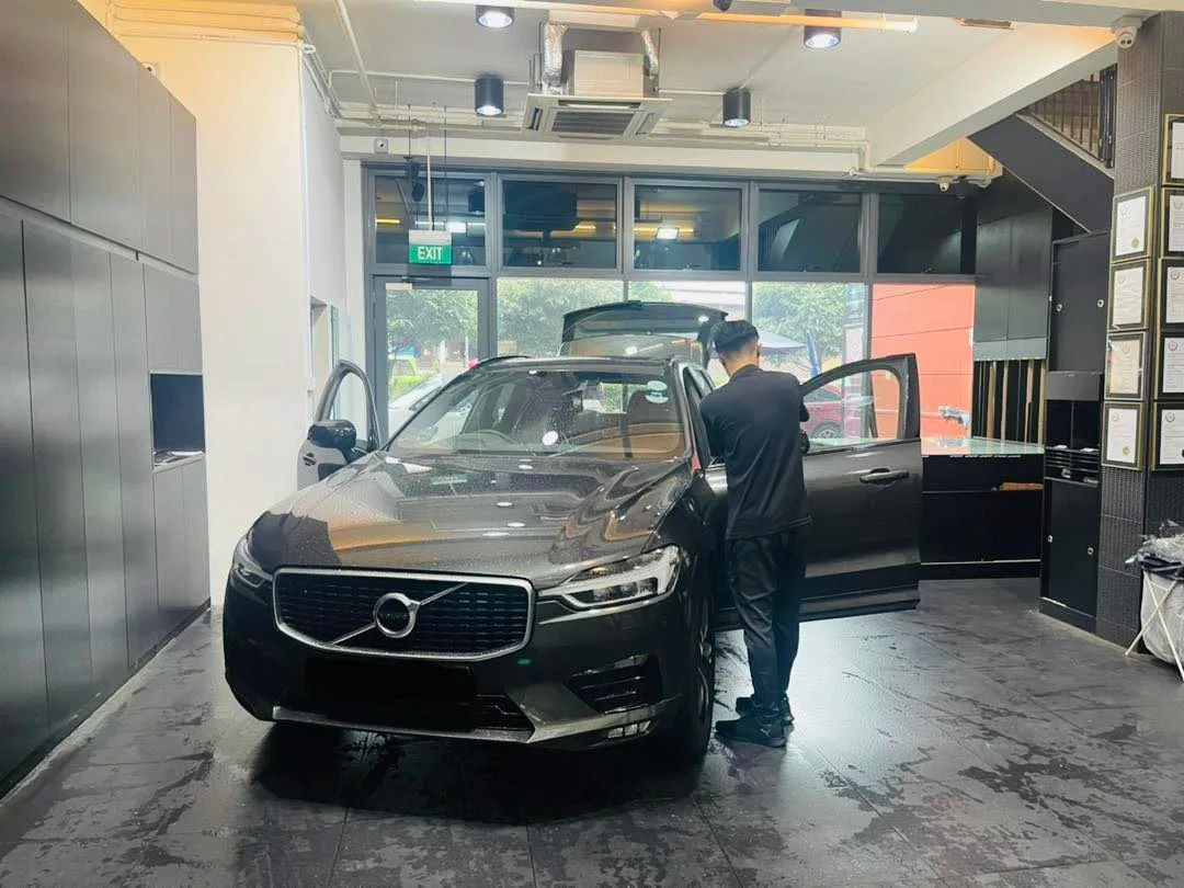 Grey Volvo XC60 SUV with doors open during window film install at Infratint Singapore