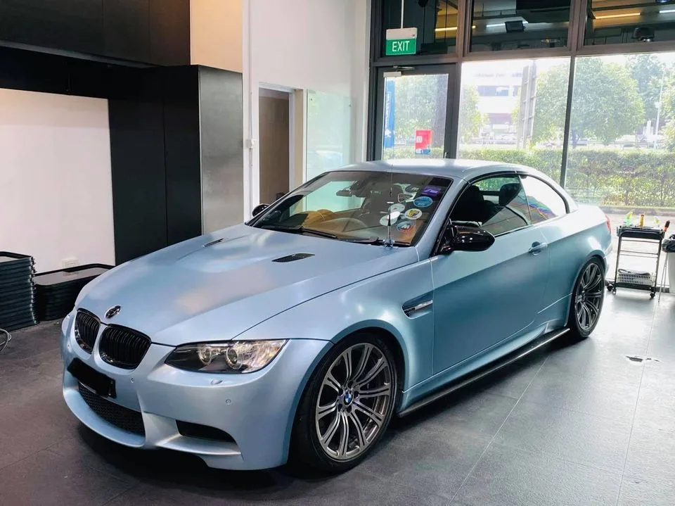 Matte ice blue BMW M3 coupe in side profile at Infratint Singapore