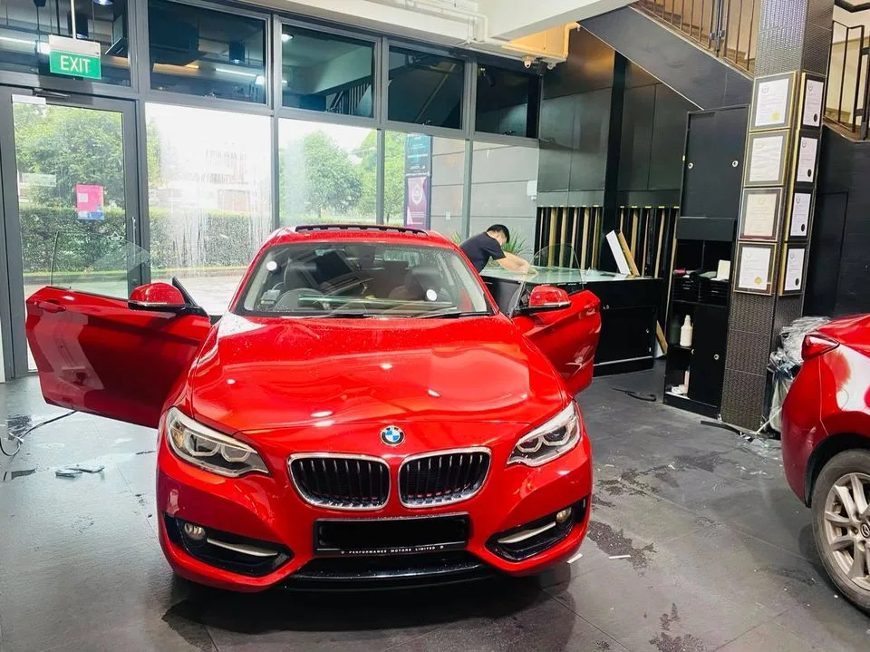 Red BMW 2 Series coupe being tinted at the windscreen at Infratint Singapore