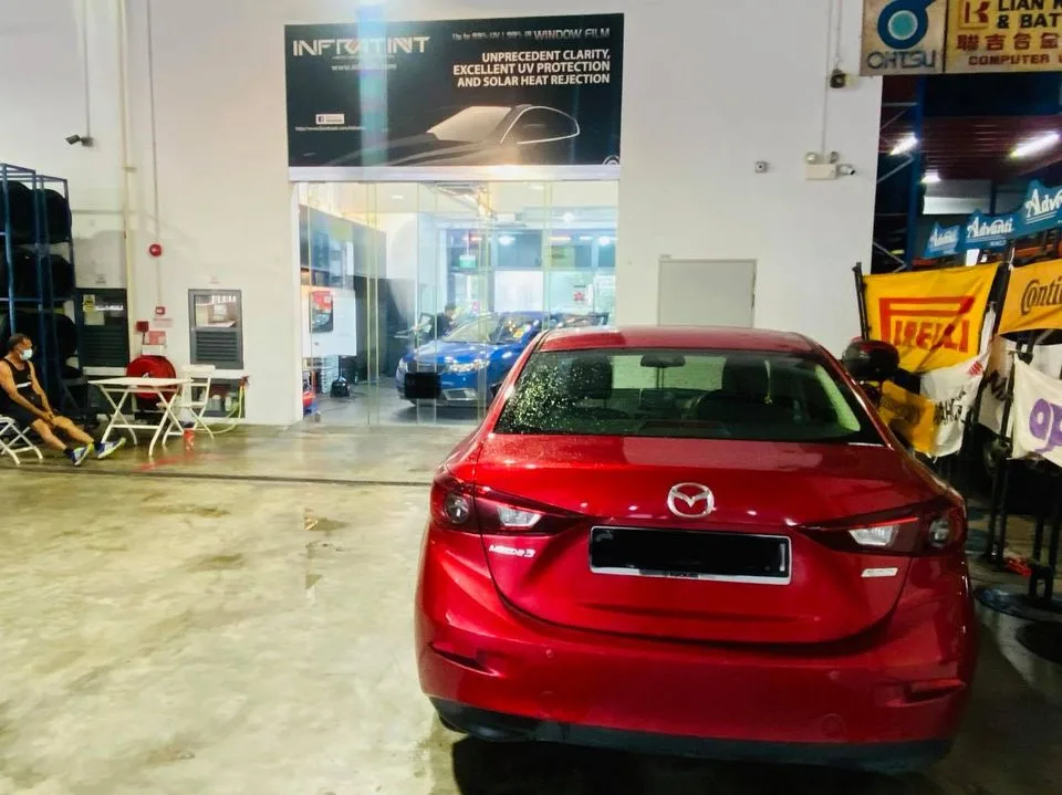 Red Mazda 3 sedan seen from the rear at Infratint Singapore