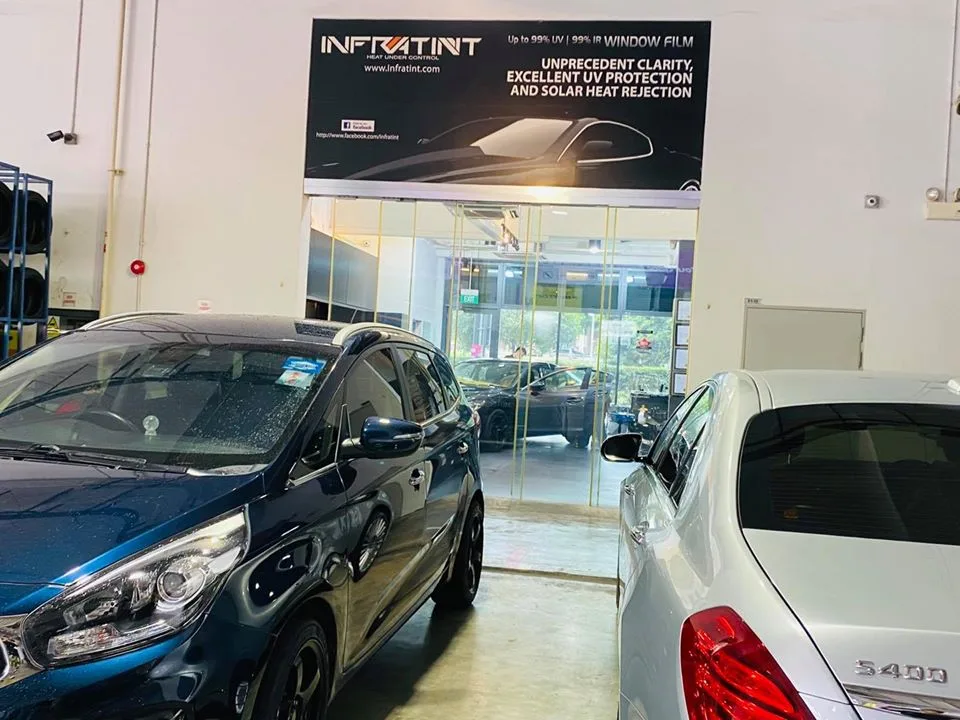 Blue Kia MPV and silver Mercedes-Benz S400 at Infratint Singapore for window tinting