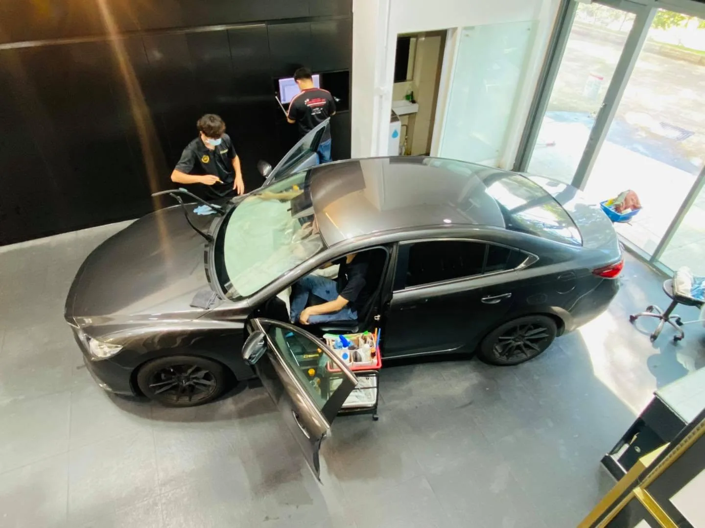 Overhead view of a dark Mazda 6 being tinted at Infratint Singapore