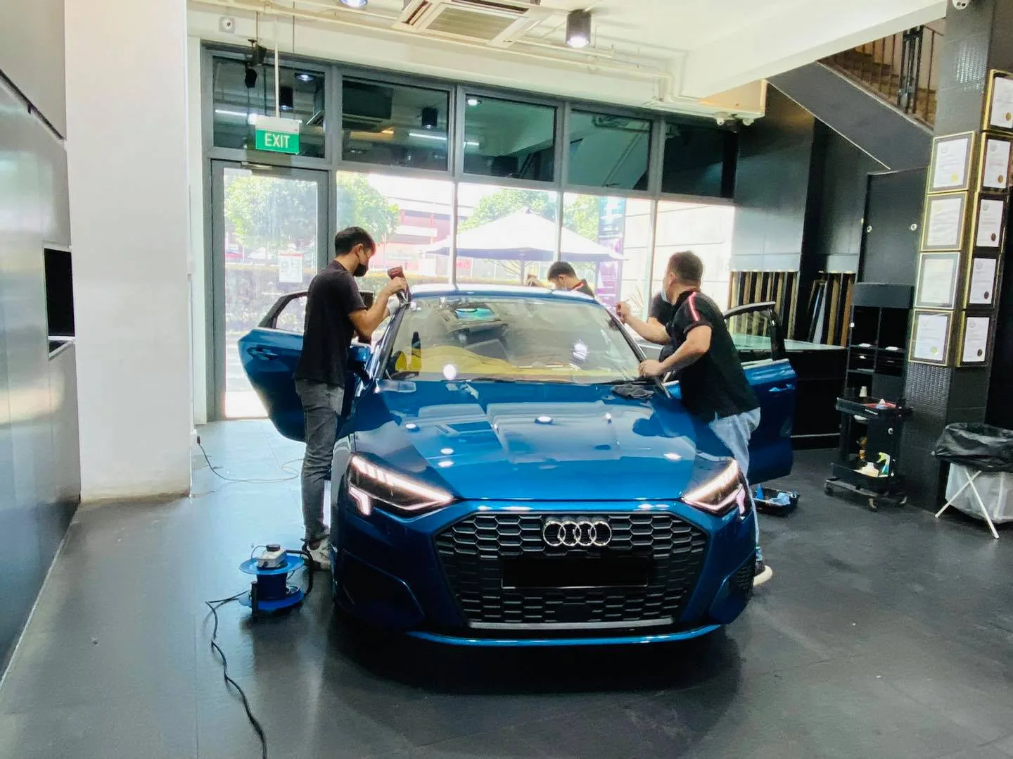Blue Audi A3 having its windscreen filmed at Infratint Singapore