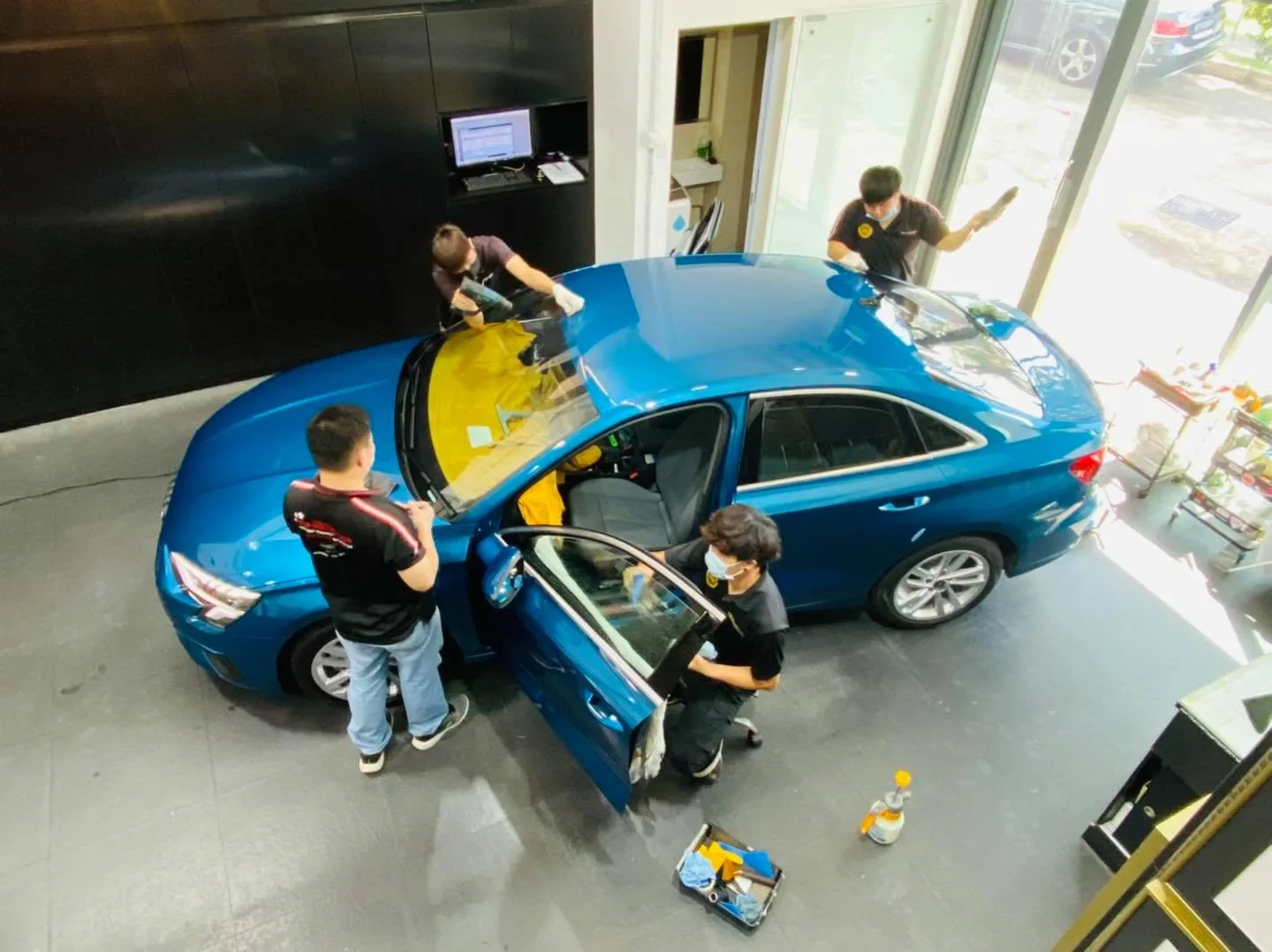Overhead shot of a blue Audi A3 having solar film applied at Infratint Singapore