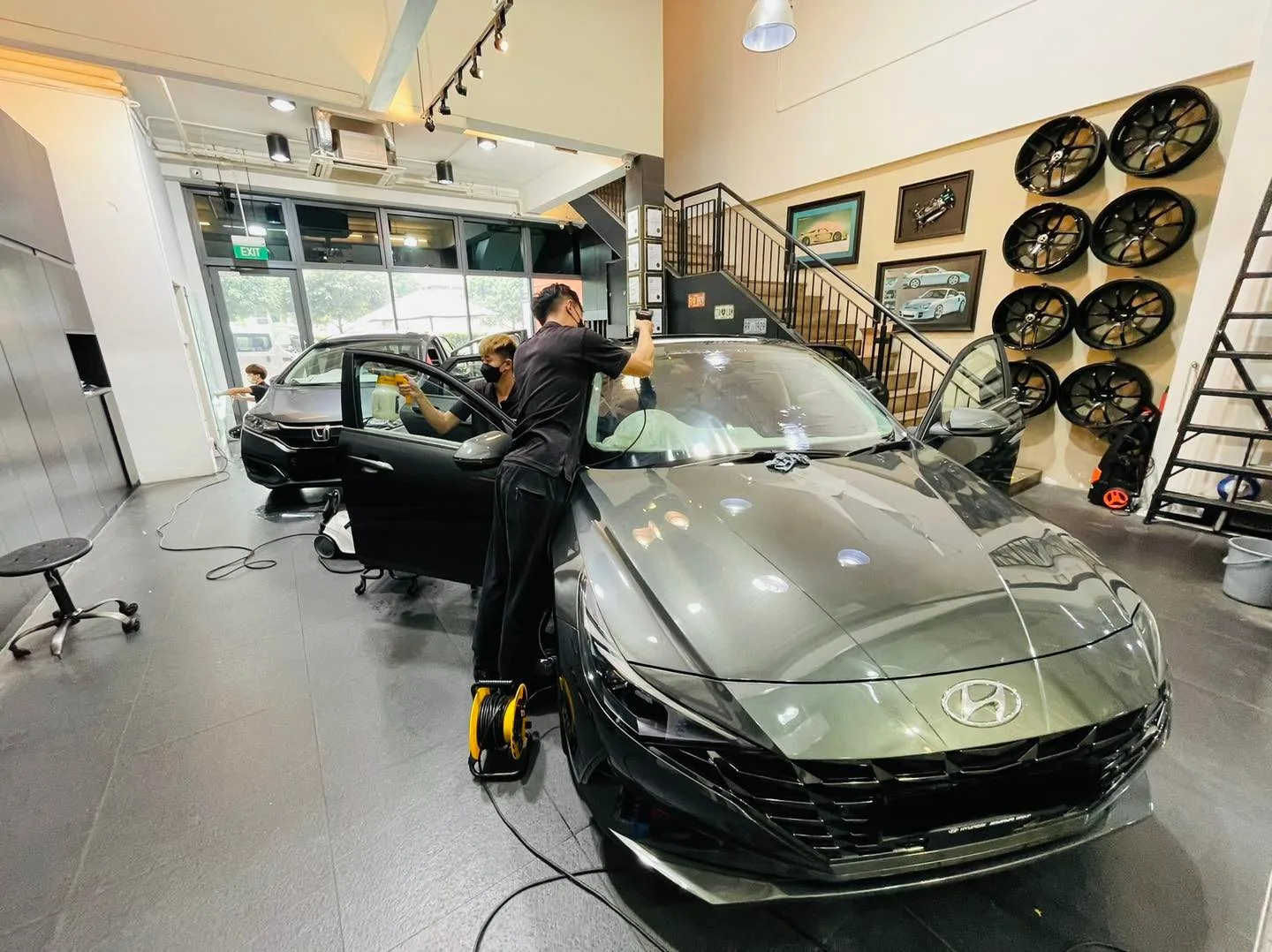 Grey Hyundai sedan being tinted by an installer at Infratint Singapore
