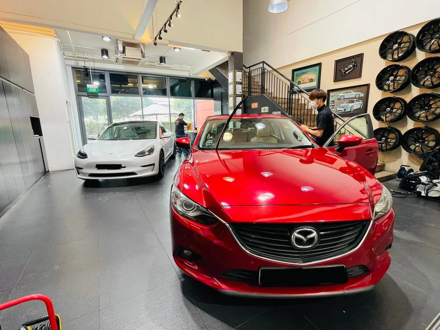 Red Mazda 6 and white Tesla Model 3 at Infratint Singapore for window tinting