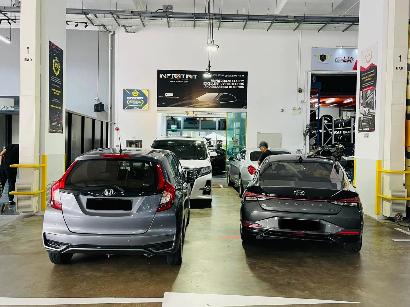 Silver Honda Jazz and grey Hyundai at Infratint Singapore window tinting workshop