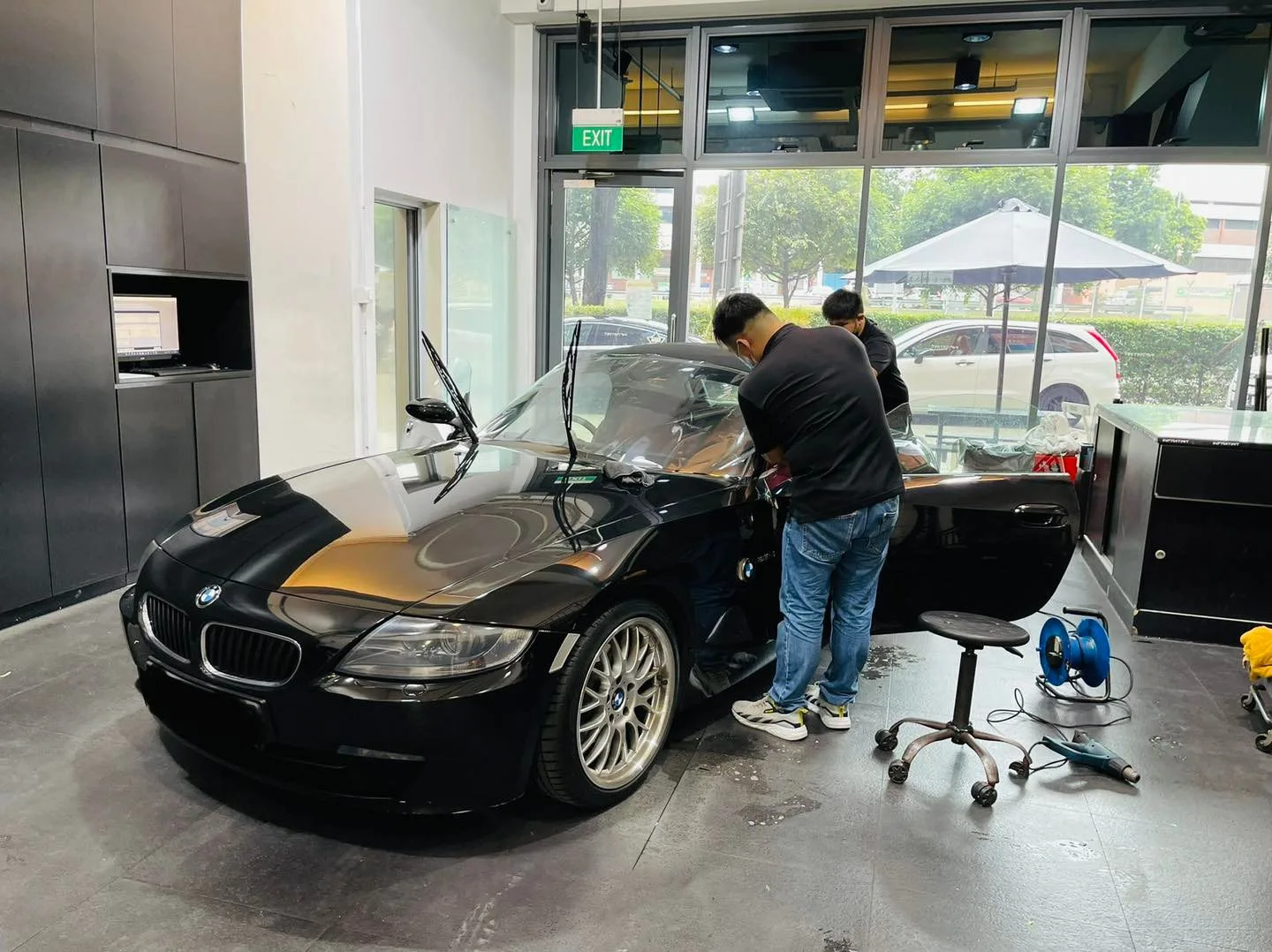 Black BMW Z4 roadster front three-quarter during window tinting at Infratint Singapore