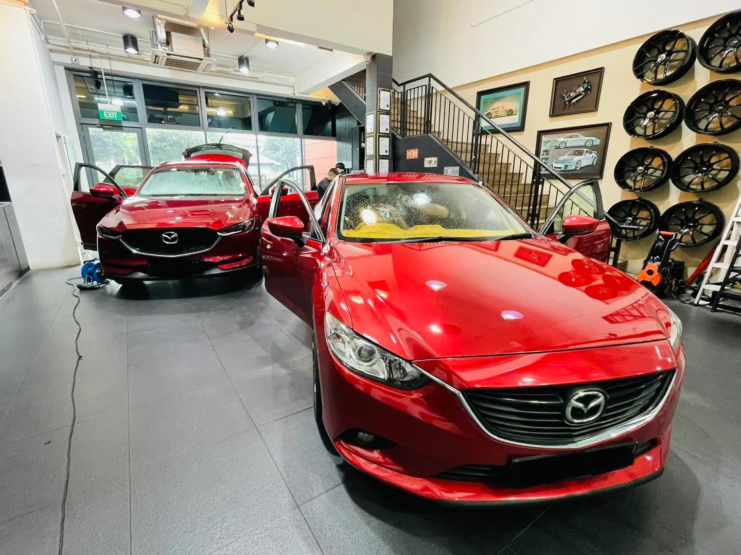 Red Mazda 6 sedan and red Mazda CX-5 inside the Infratint Singapore showroom for window tinting