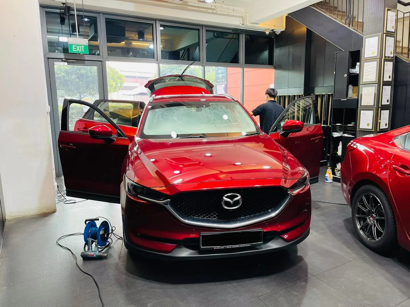 Red Mazda CX-5 being prepared for window film at Infratint Singapore