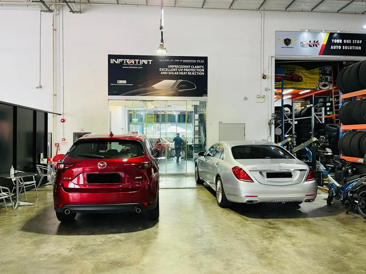 Red Mazda CX-5 and silver Mercedes-Benz S-Class in the Infratint Singapore install bay