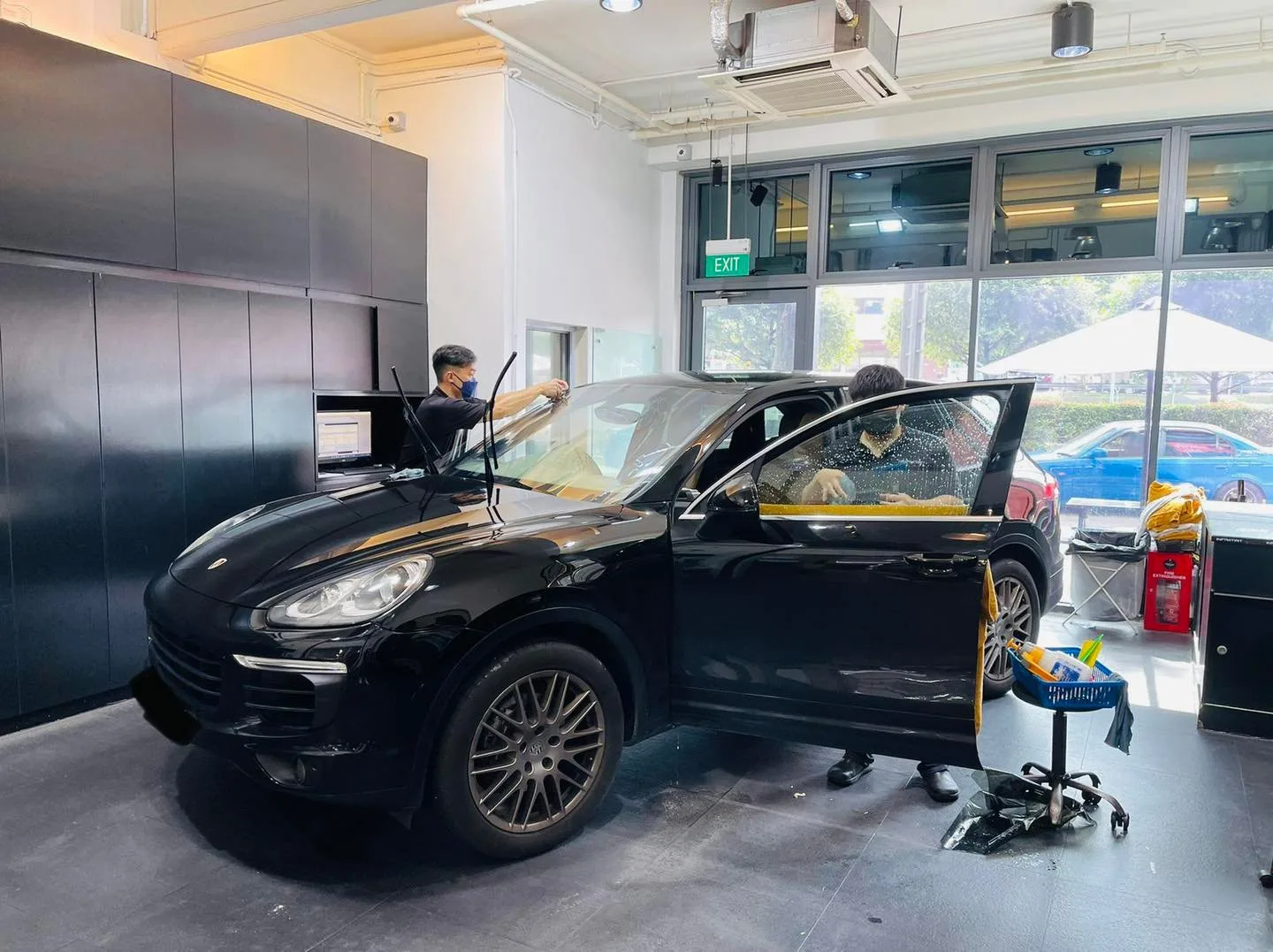 Black Porsche Cayenne SUV side view during tinting at Infratint Singapore