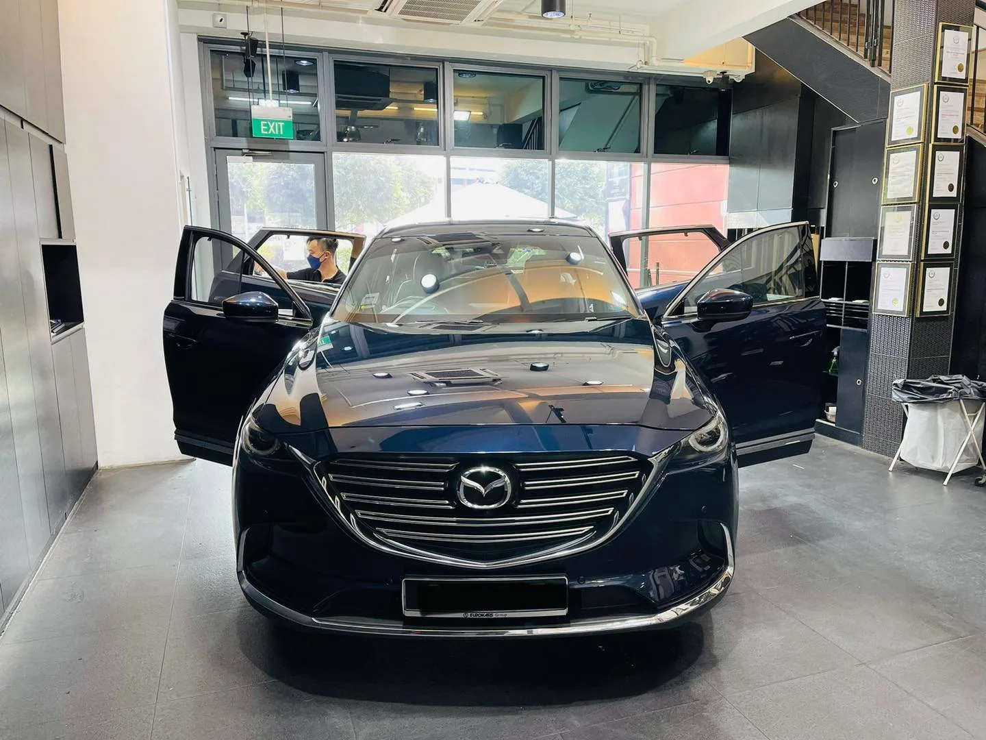 Dark blue Mazda CX-9 SUV with doors open at Infratint Singapore for window tinting