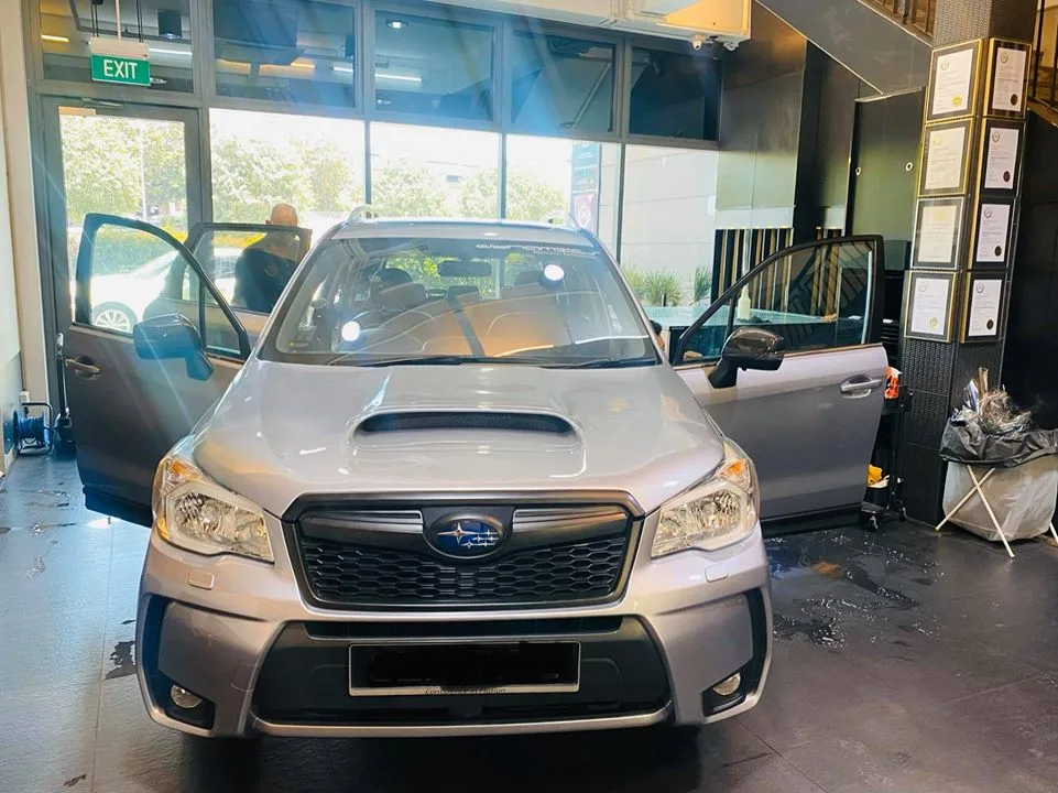 Silver Subaru Forester SUV being prepared for window tinting at Infratint Singapore