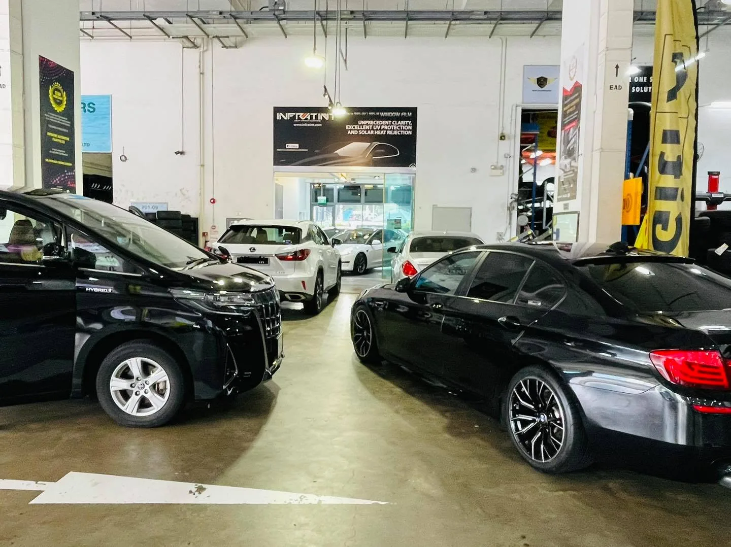 Black Toyota Alphard and grey BMW 5 Series at Infratint Singapore for window film