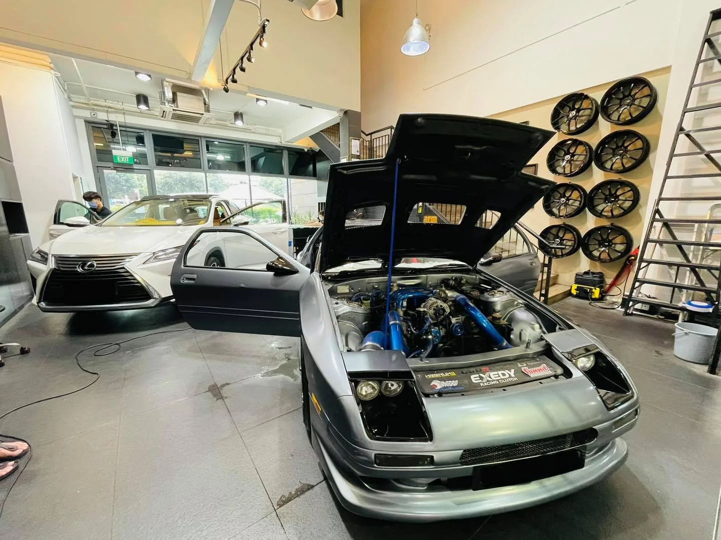 Silver Mazda RX7 FC3S with bonnet up showing the engine bay at Infratint Singapore