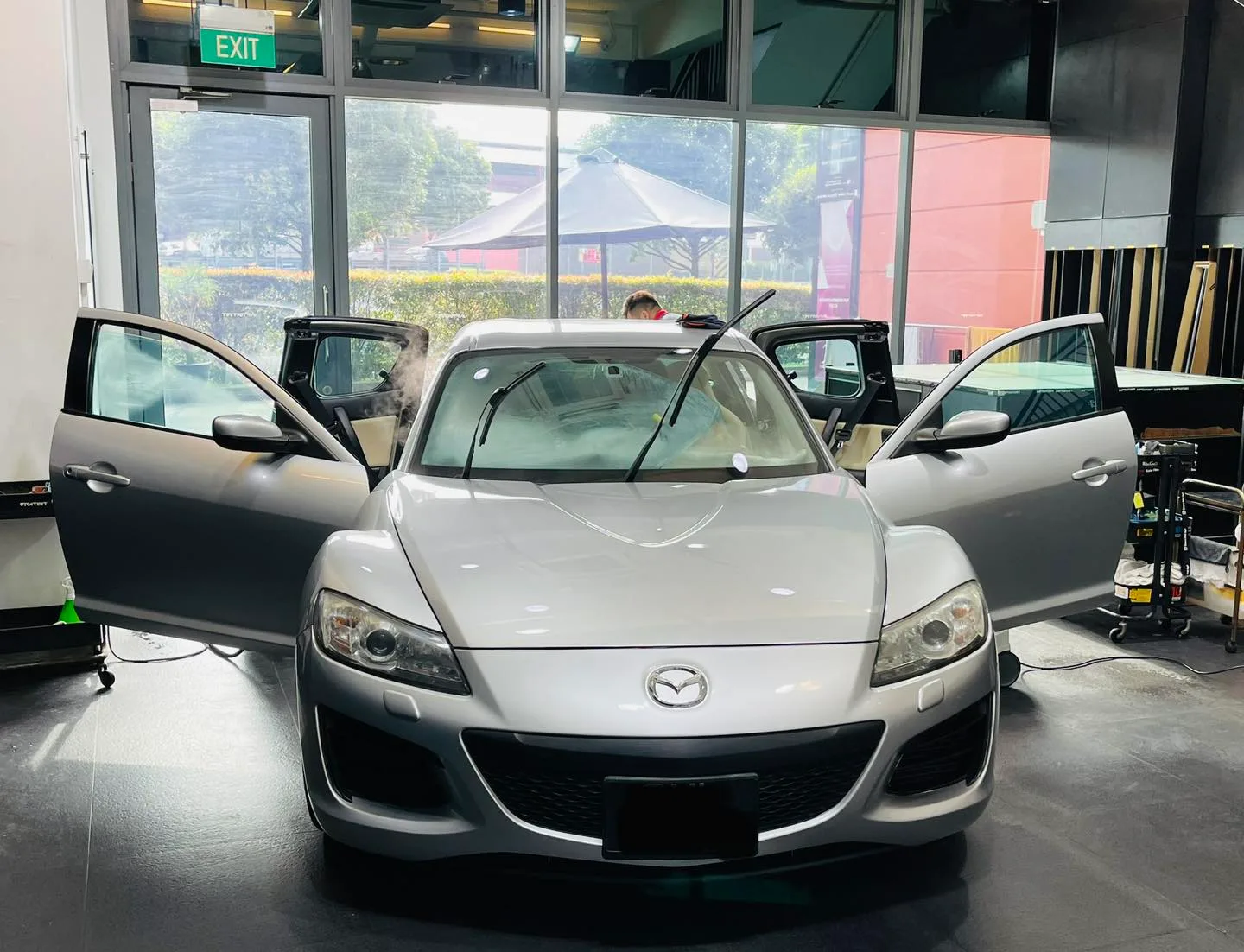 Silver Mazda RX-8 coupe with doors open at Infratint Singapore for window film