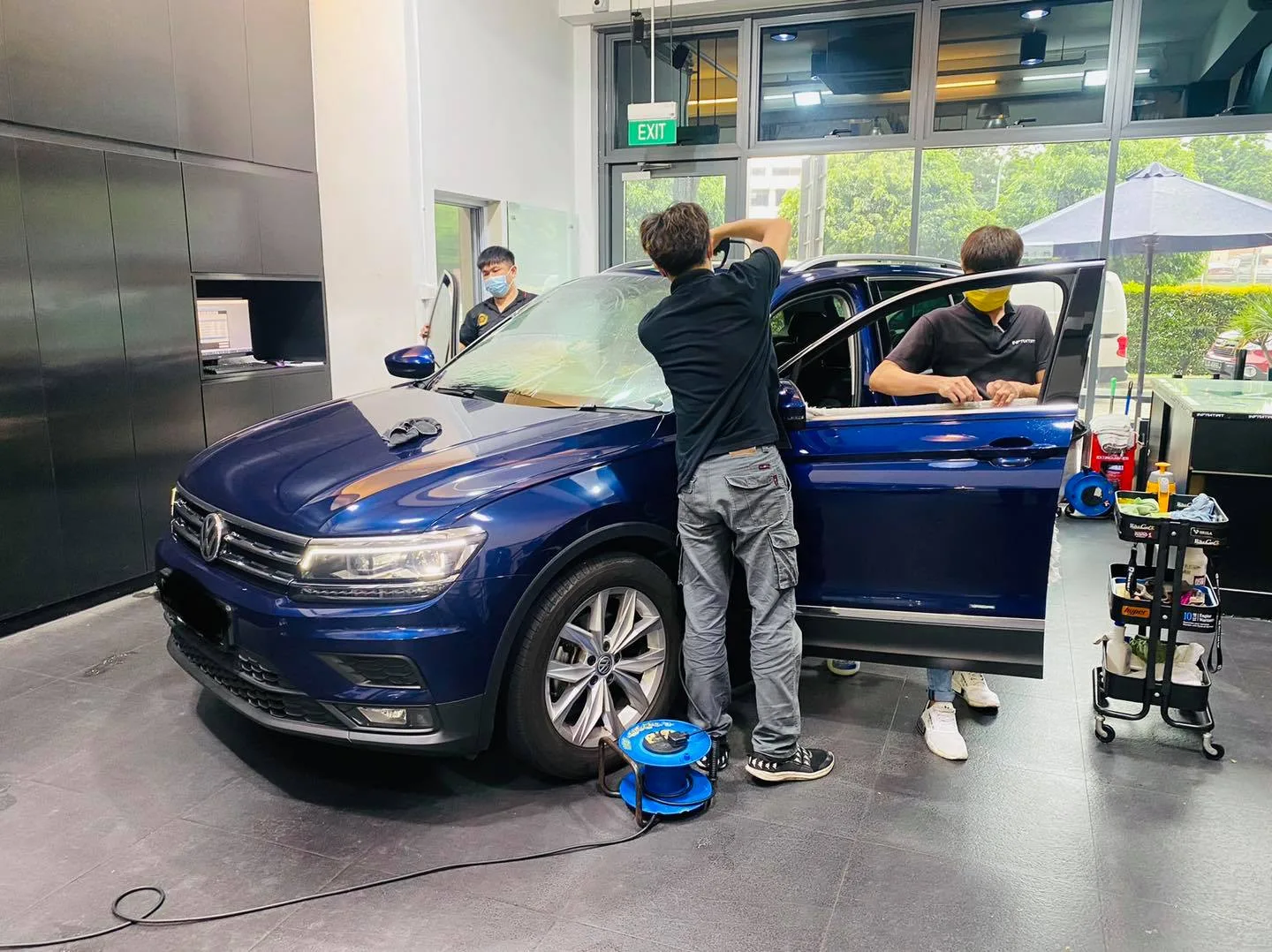 Blue Volkswagen Tiguan having its side windows tinted at Infratint Singapore
