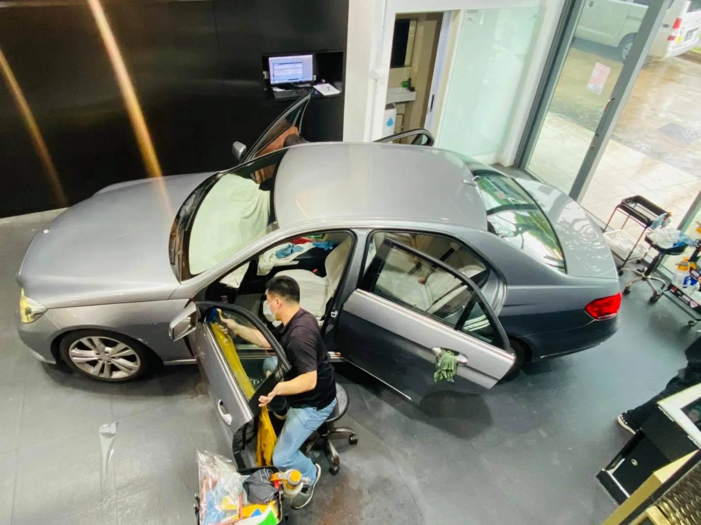Overhead view of tint installation on a grey Mercedes-Benz E-Class at Infratint Singapore