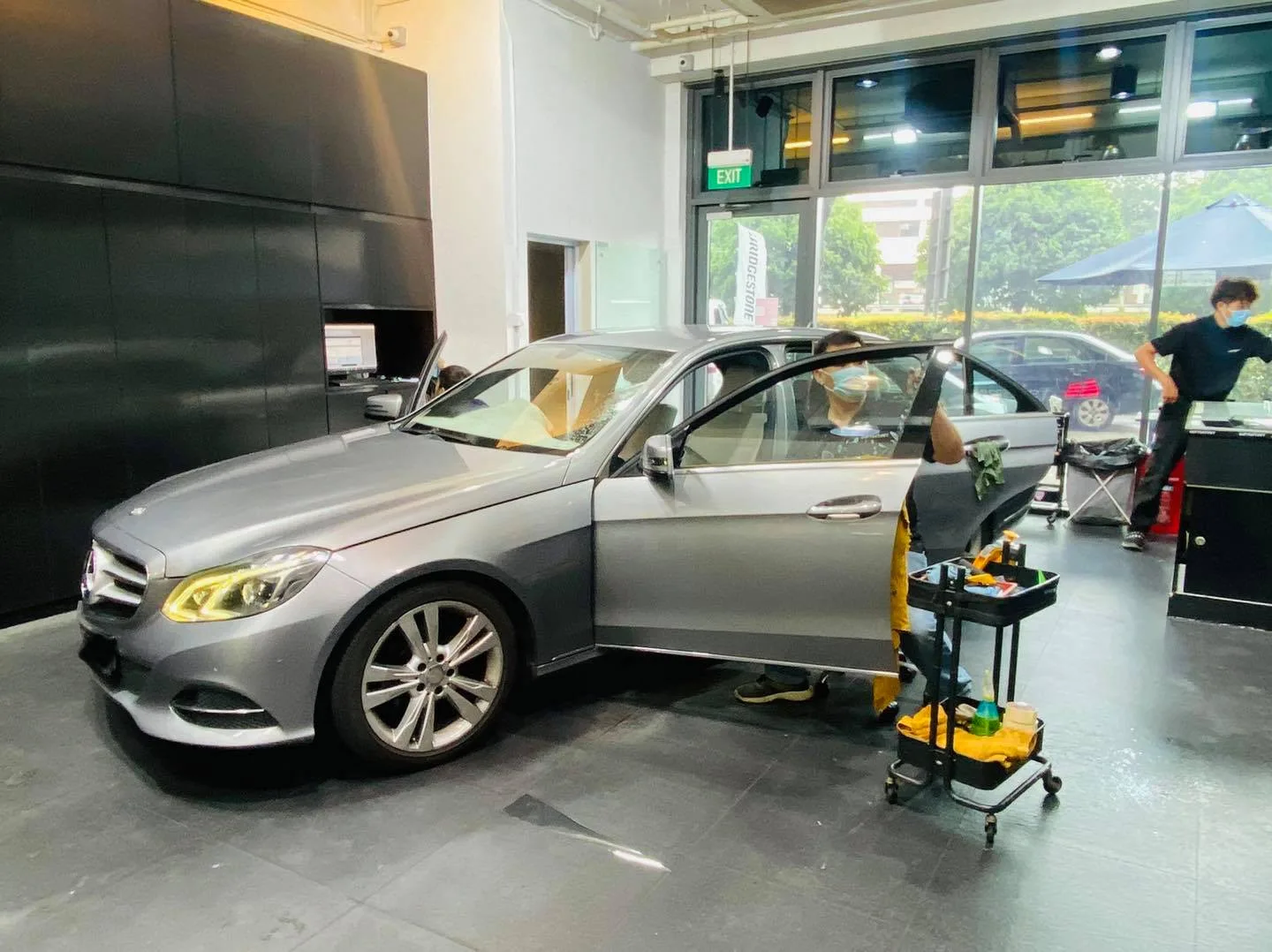 Installer working on a grey Mercedes-Benz E-Class side door at Infratint Singapore