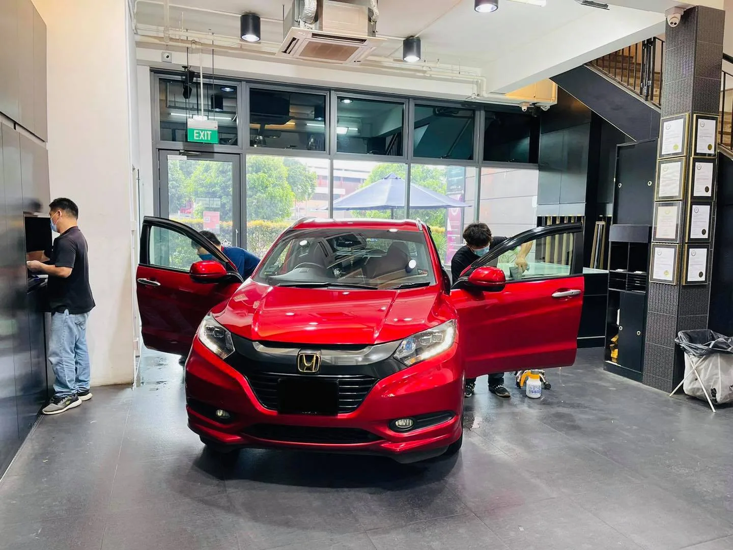 Red Honda HR-V with doors open during window tinting at Infratint Singapore