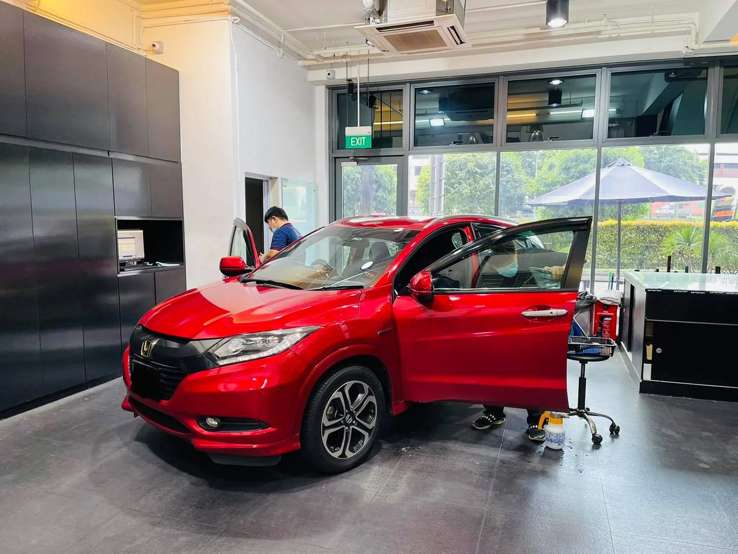 Red Honda HR-V front three-quarter view during tint install at Infratint Singapore