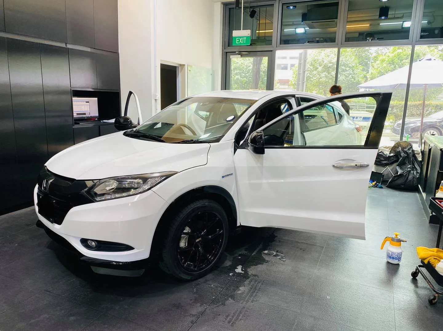 Front three-quarter view of a white Honda SUV on black wheels at Infratint Singapore