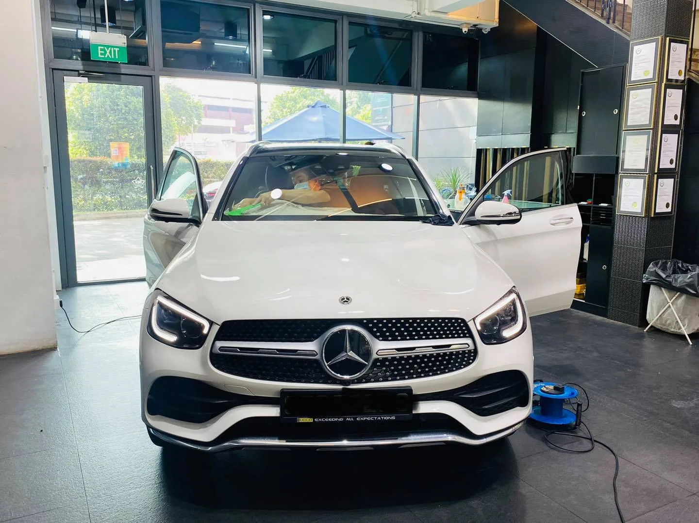 White Mercedes-Benz SUV front view during window tinting at Infratint Singapore