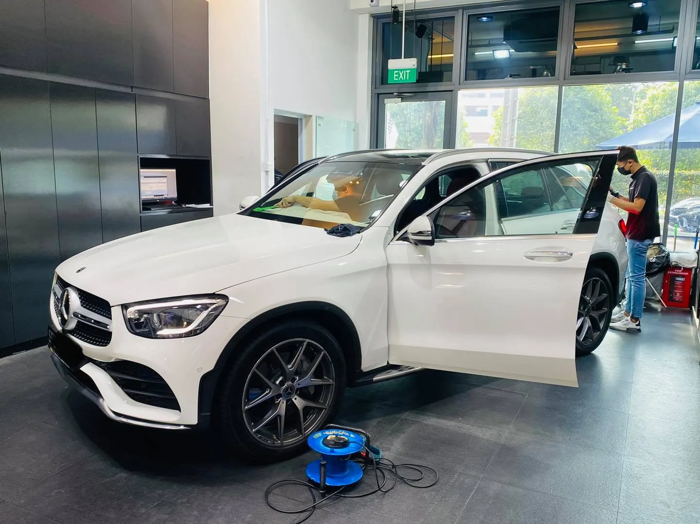 Side view of a white Mercedes-Benz SUV being tinted at Infratint Singapore