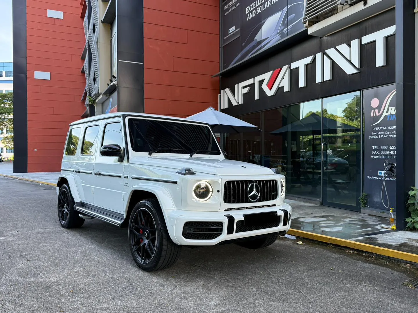Tinted white Mercedes-AMG G63 front three-quarter view outside Infratint Singapore