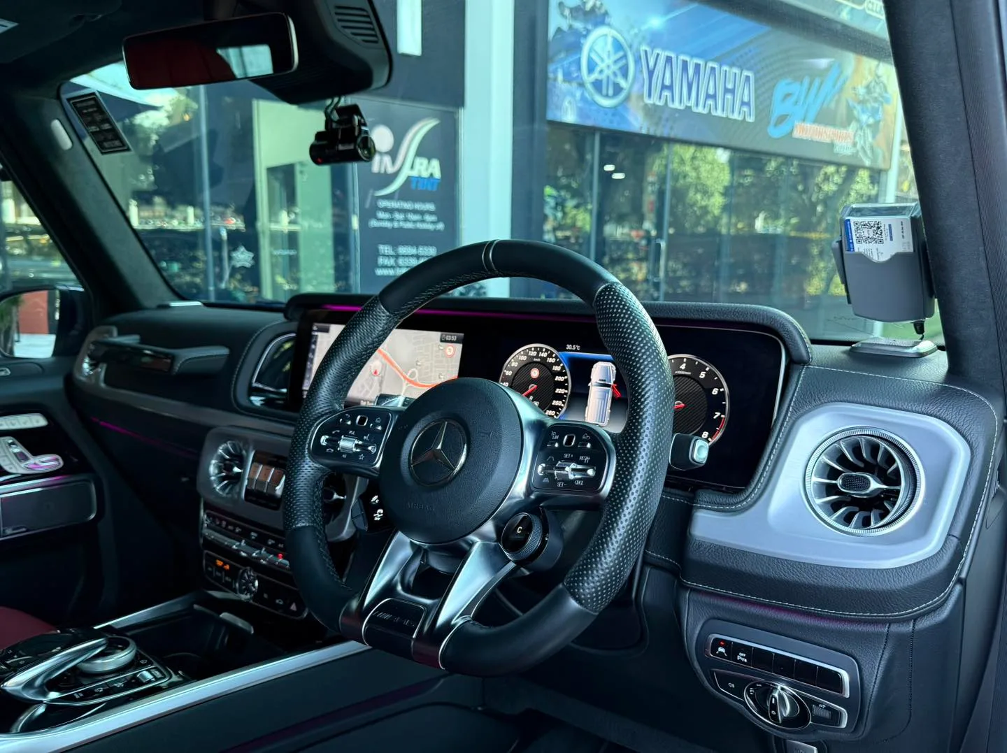 Mercedes-AMG G63 cockpit and digital displays seen through tinted glass at Infratint Singapore