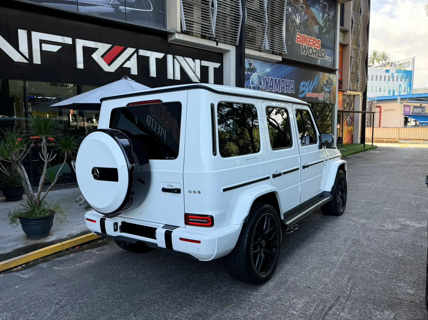 Tinted white Mercedes-AMG G63 rear three-quarter view with spare wheel at Infratint Singapore