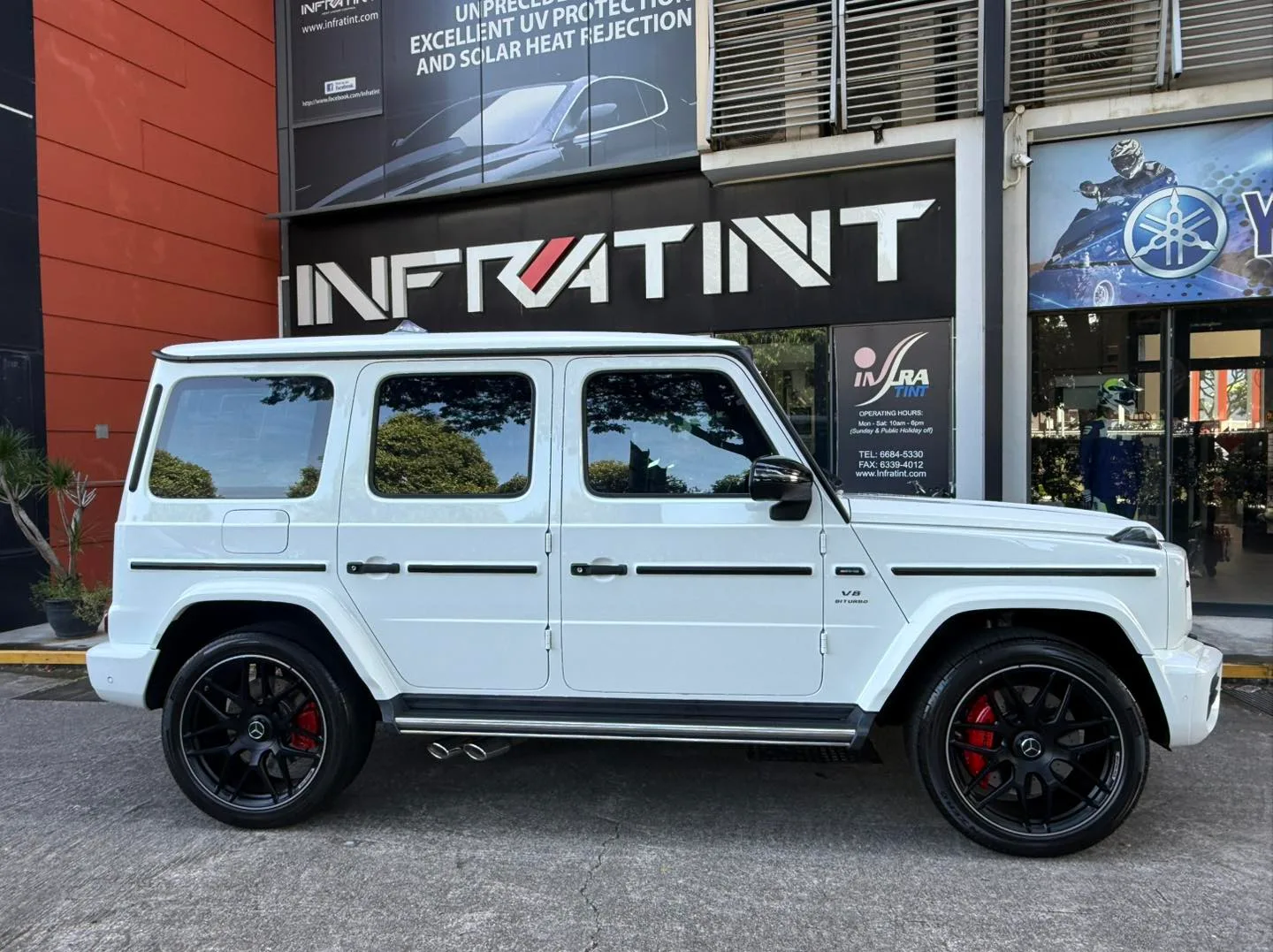 Tinted white Mercedes-AMG G63 side profile outside the Infratint shopfront in Singapore