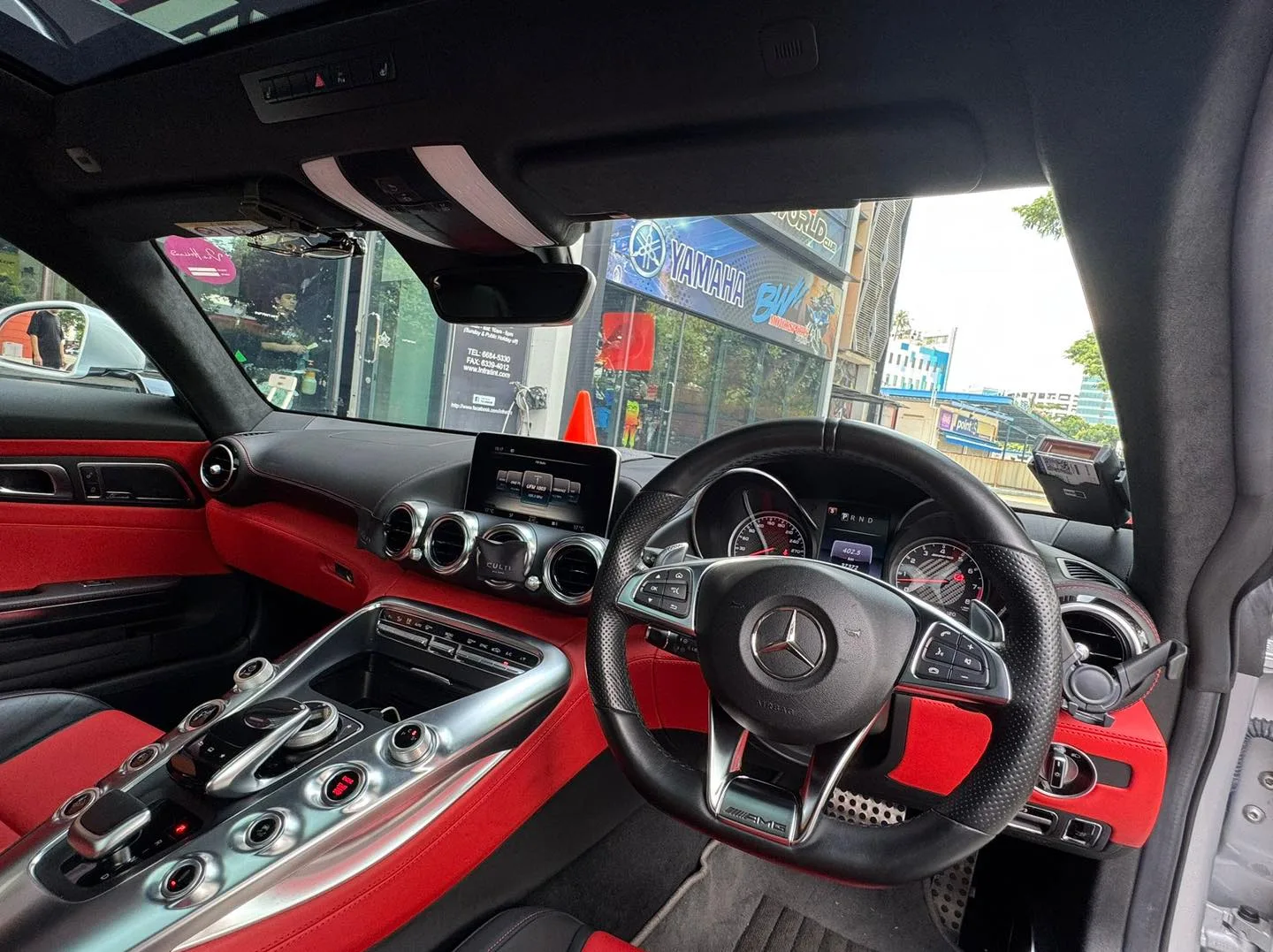 Mercedes-AMG GT red leather interior seen through tinted glass at Infratint Singapore