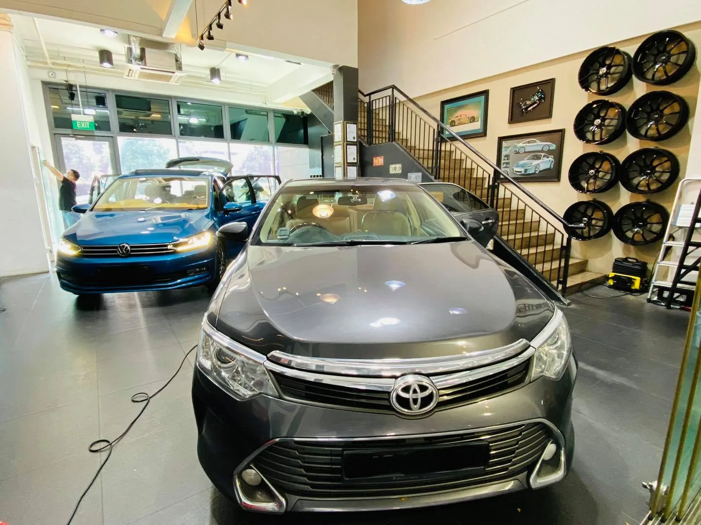 Grey Toyota Camry head-on with a blue Volkswagen at Infratint Singapore for tinting