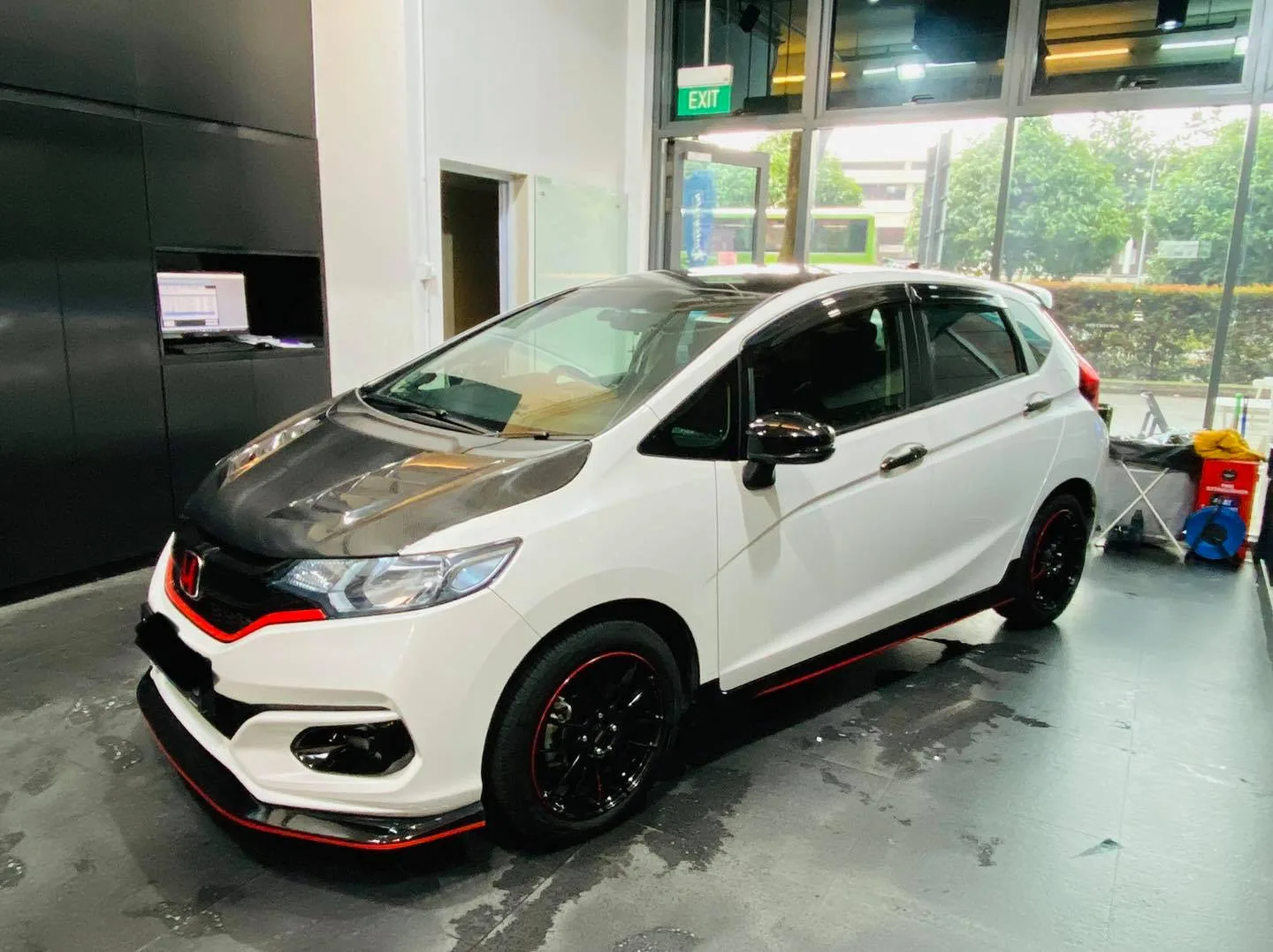 White Honda Jazz with carbon bonnet in side profile at Infratint Singapore for window film