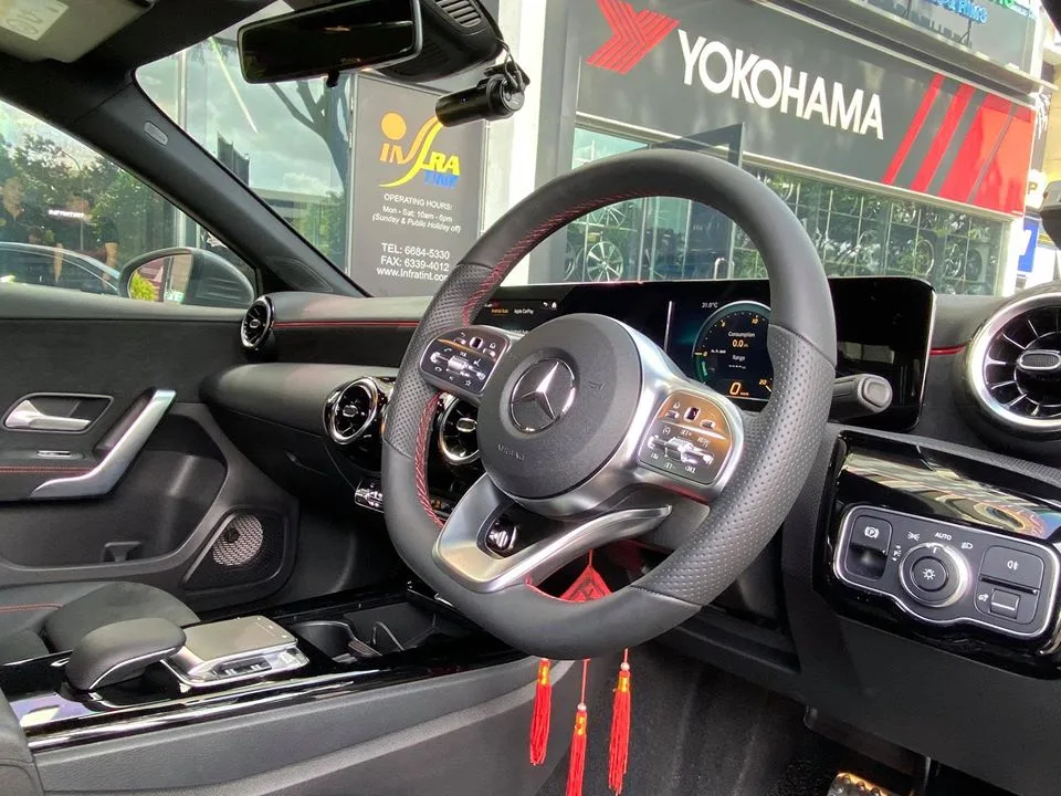 Mercedes-Benz A200 AMG dual-screen interior seen through tinted glass at Infratint Singapore