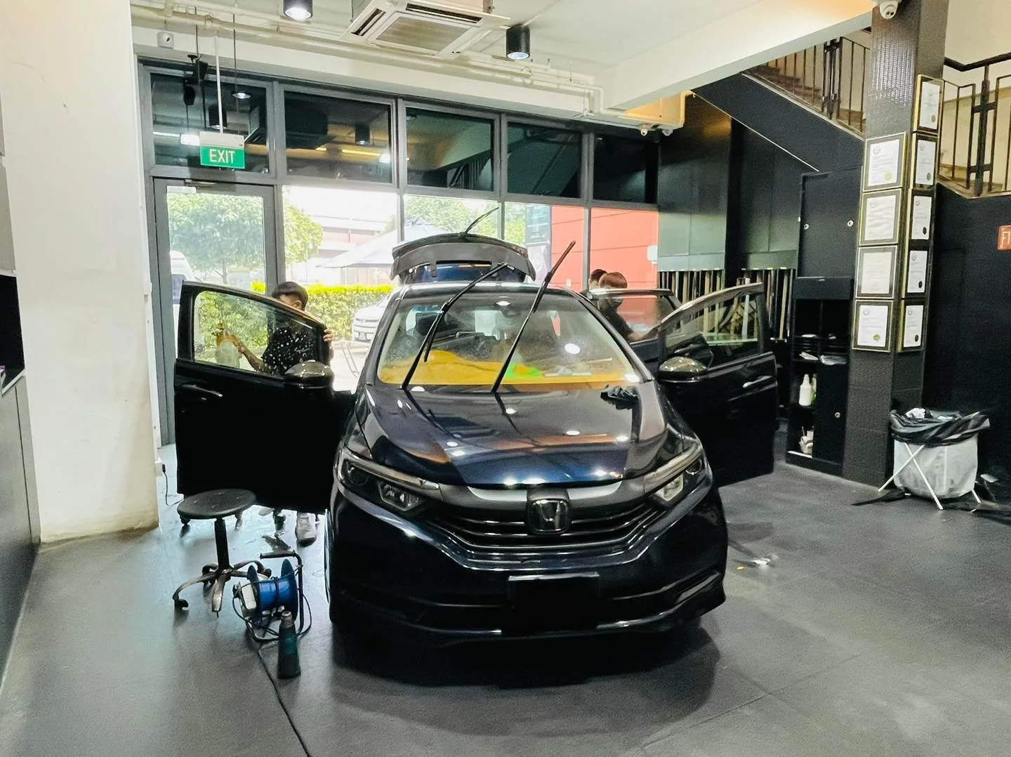 Black Honda wagon with doors open during window tinting at Infratint Singapore
