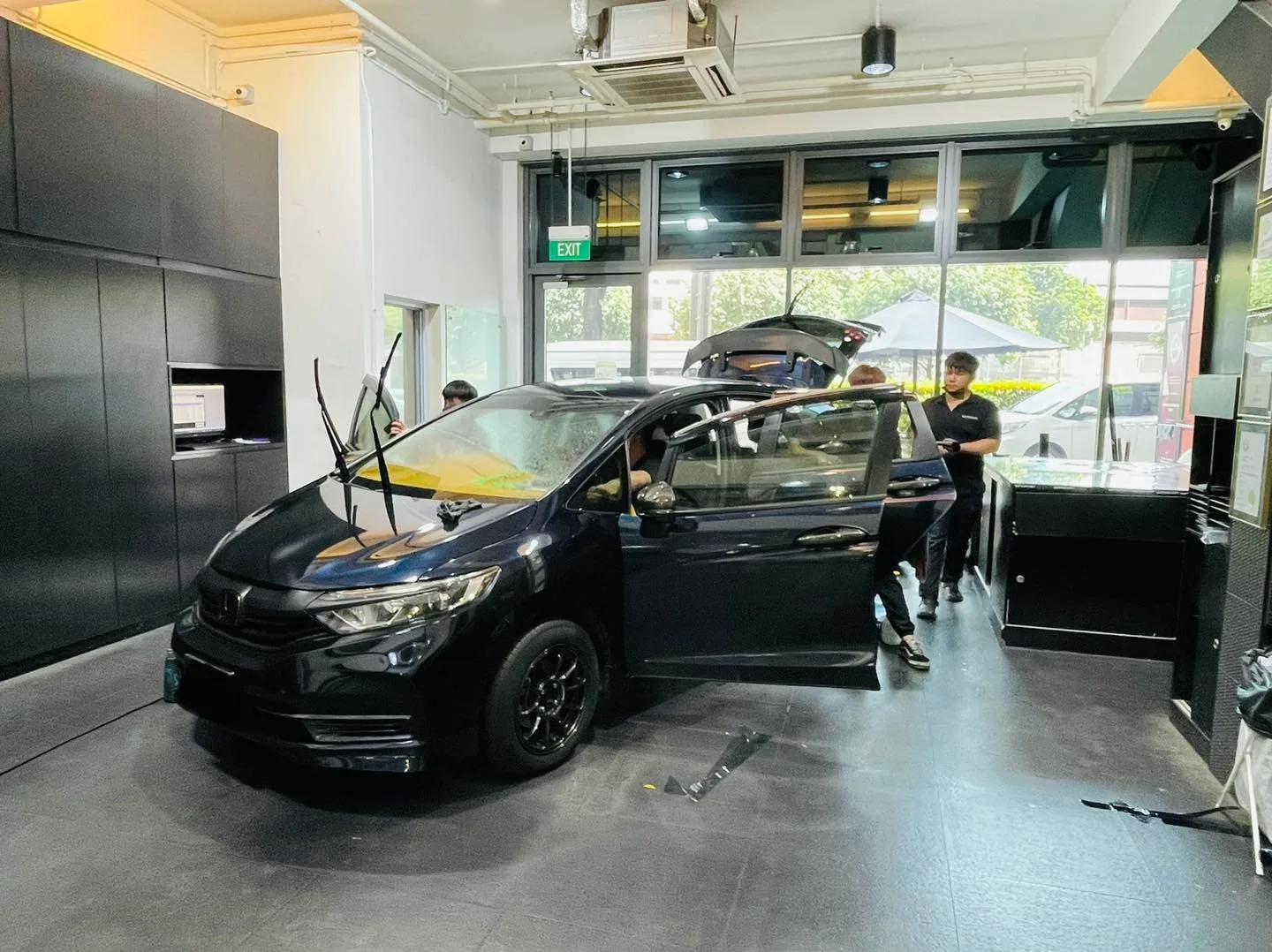 Black Honda estate during window film installation at Infratint Singapore