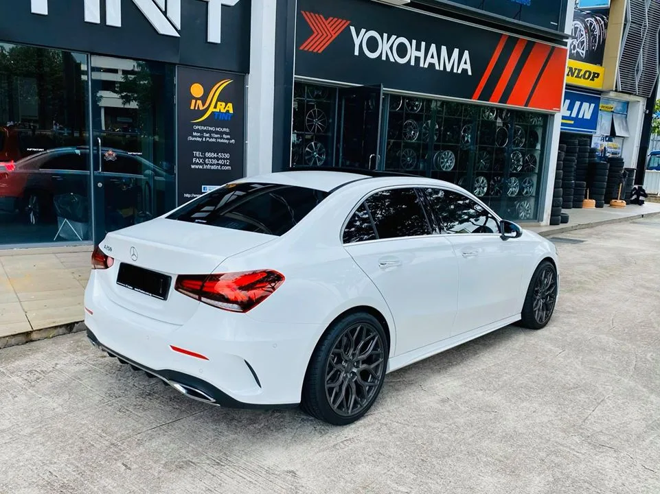 Rear three-quarter view of a white Mercedes-Benz A-Class with tinted windows at Infratint Singapore
