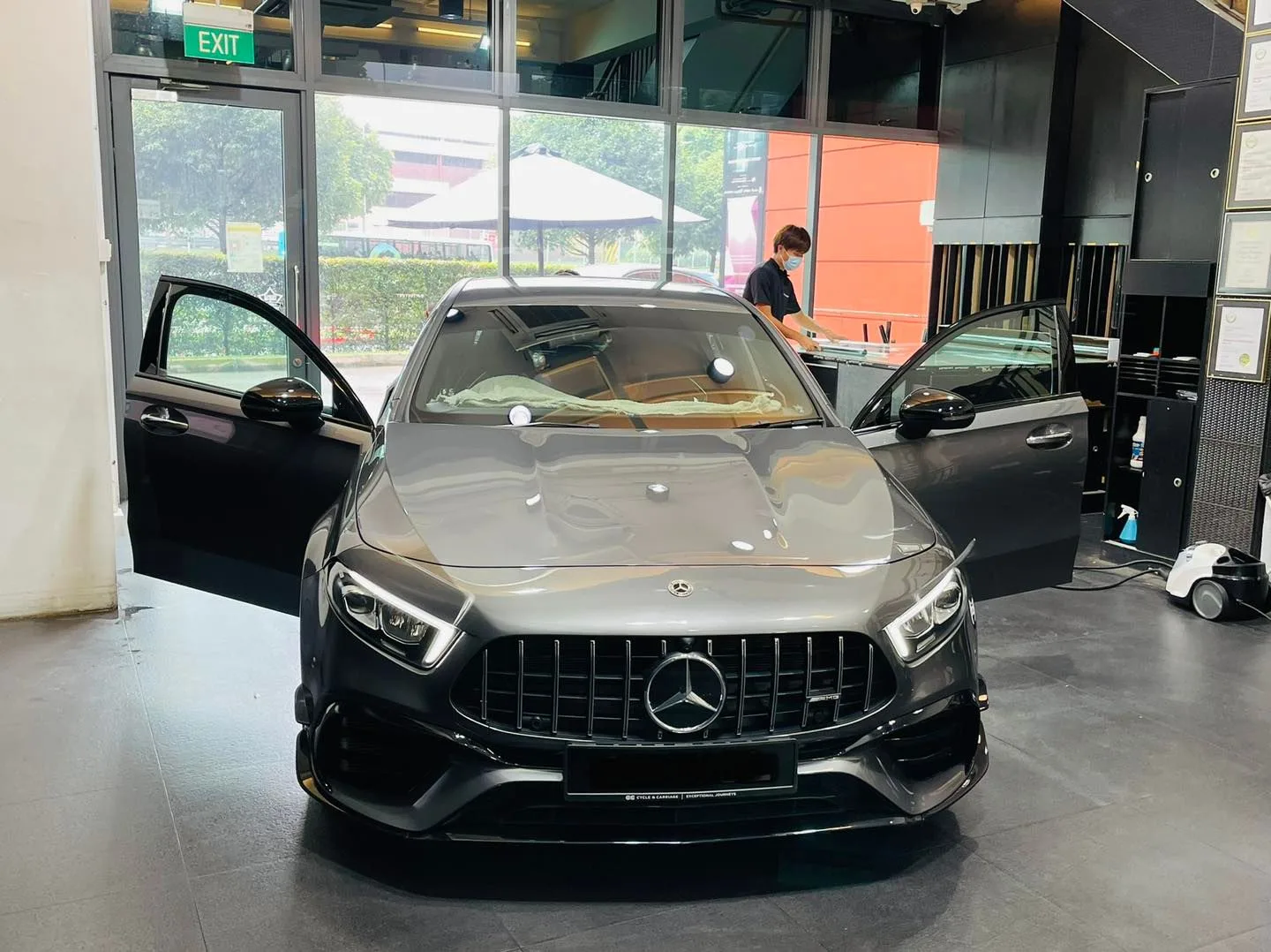 Grey Mercedes-AMG A45 S hatch with driver door open at Infratint Singapore for window tinting