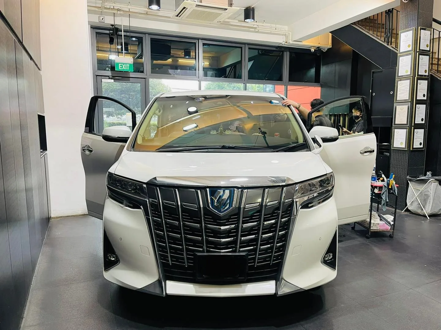 White Toyota Alphard MPV with front doors open at Infratint Singapore for window film