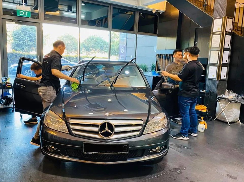 Grey Mercedes-Benz sedan being prepped for window tinting by the team at Infratint Singapore