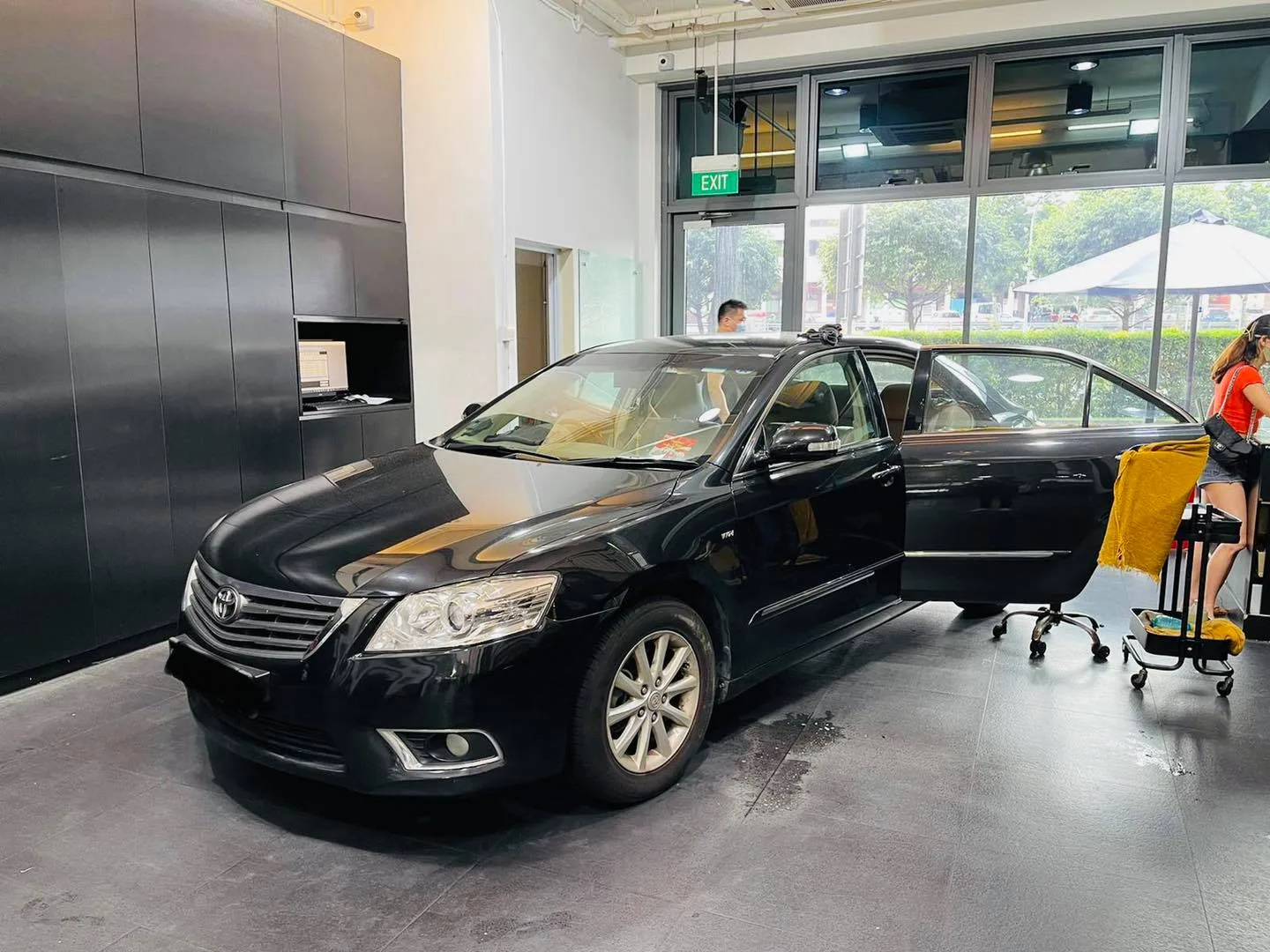 Black Toyota Camry being prepared for window tinting at Infratint Singapore