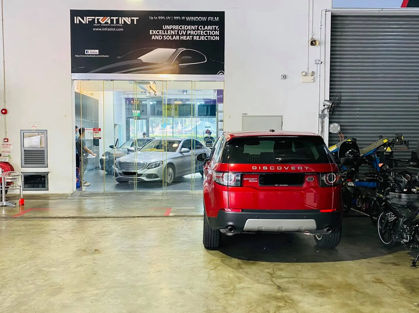 Red Land Rover Discovery inside the Infratint Singapore install bay