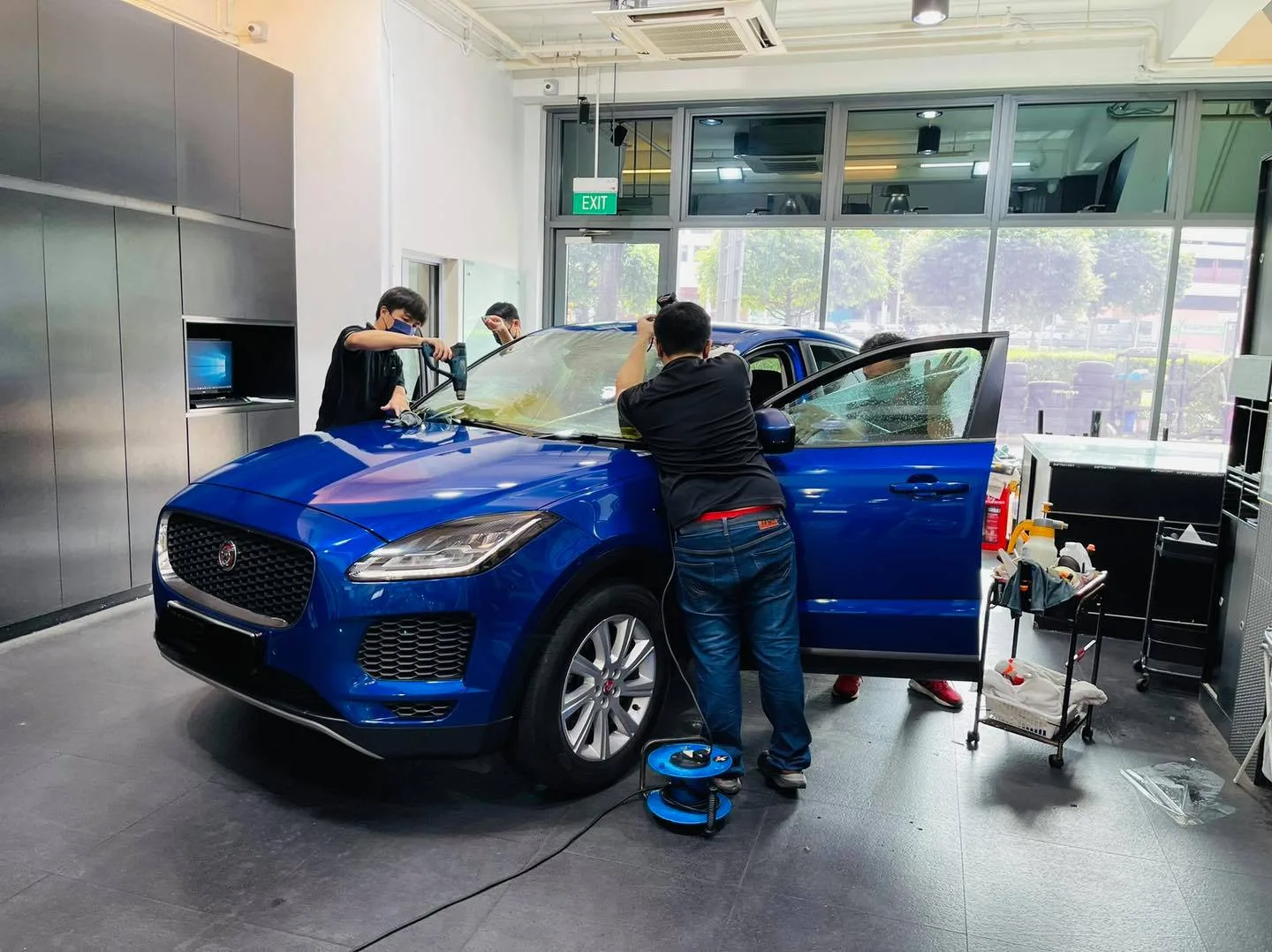Blue Jaguar E-Pace SUV being tinted from the side at Infratint Singapore