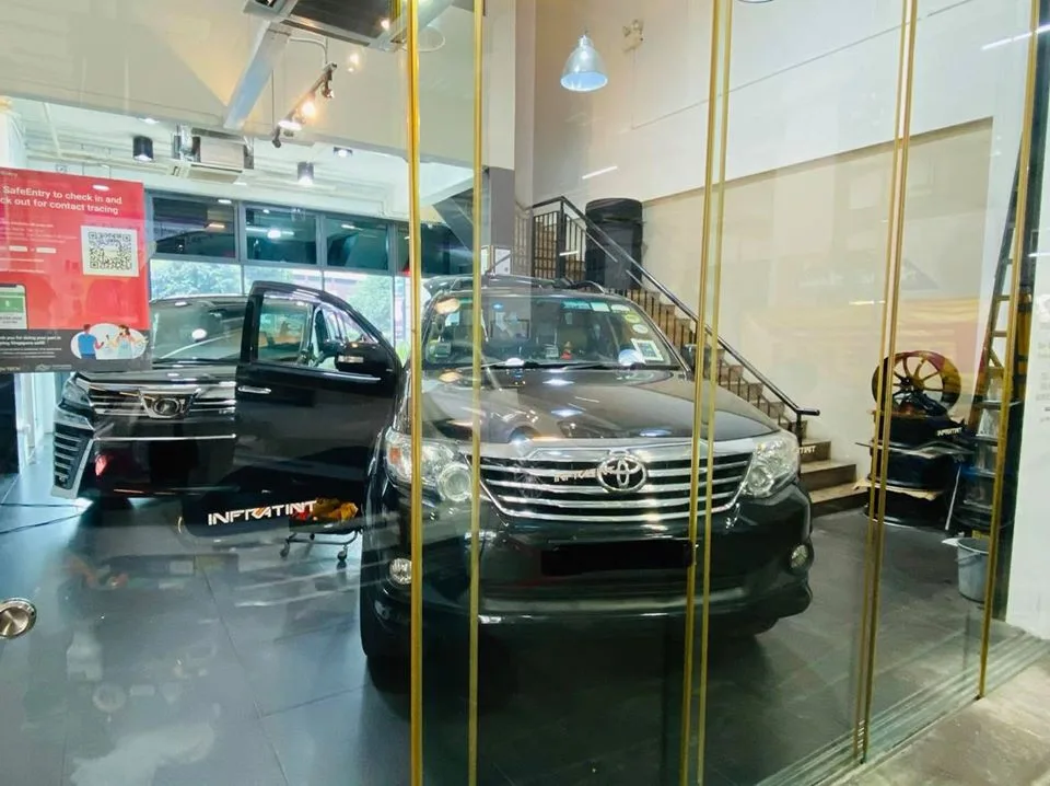 Black Toyota Fortuner SUV viewed through glass doors at Infratint Singapore